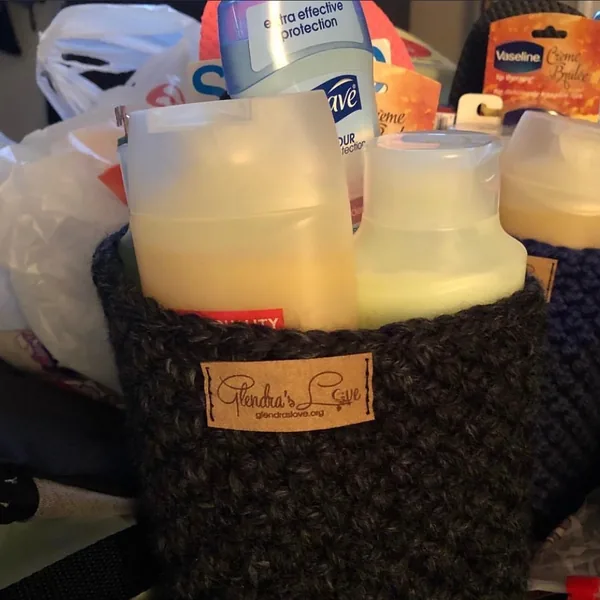 A crocheted basket filled with toiletries, with a Glendra’s Love tag