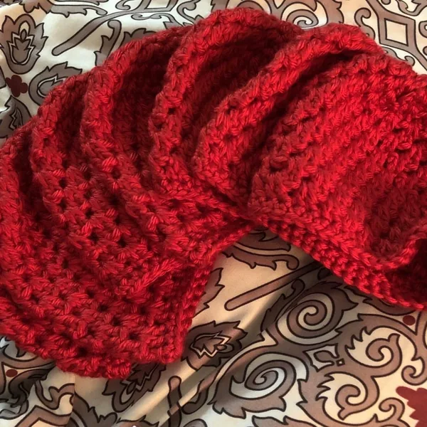 A stack of red crocheted hats